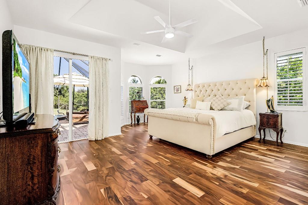 4001 Marianne Key Road Punta Gorda, FL 33955 - Photo 4 of 29 a living room with a bed furniture flat screen tv and large windows