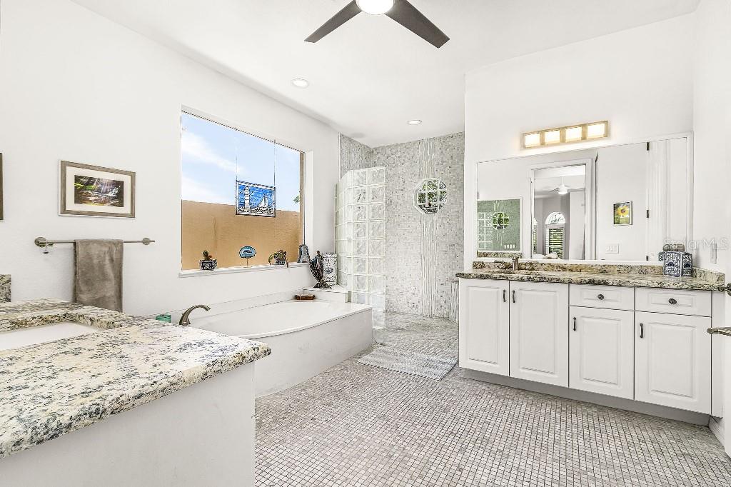 4001 Marianne Key Road Punta Gorda, FL 33955 - Photo 7 of 29 a spacious bathroom with a granite countertop tub sink and mirror