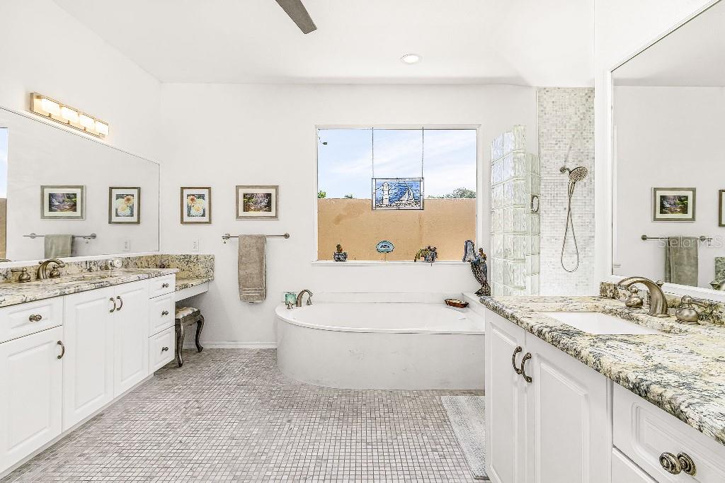 4001 Marianne Key Road Punta Gorda, FL 33955 - Photo 8 of 29 a bathroom with a granite countertop sink mirror and bathtub