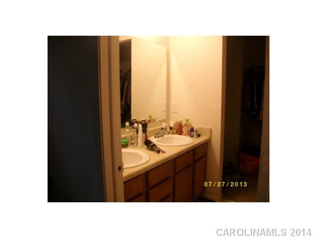8624 Rockmoor Ridge Road Charlotte, NC 28215 - Photo 6 of 7 a bathroom with a sink vanity and a mirror