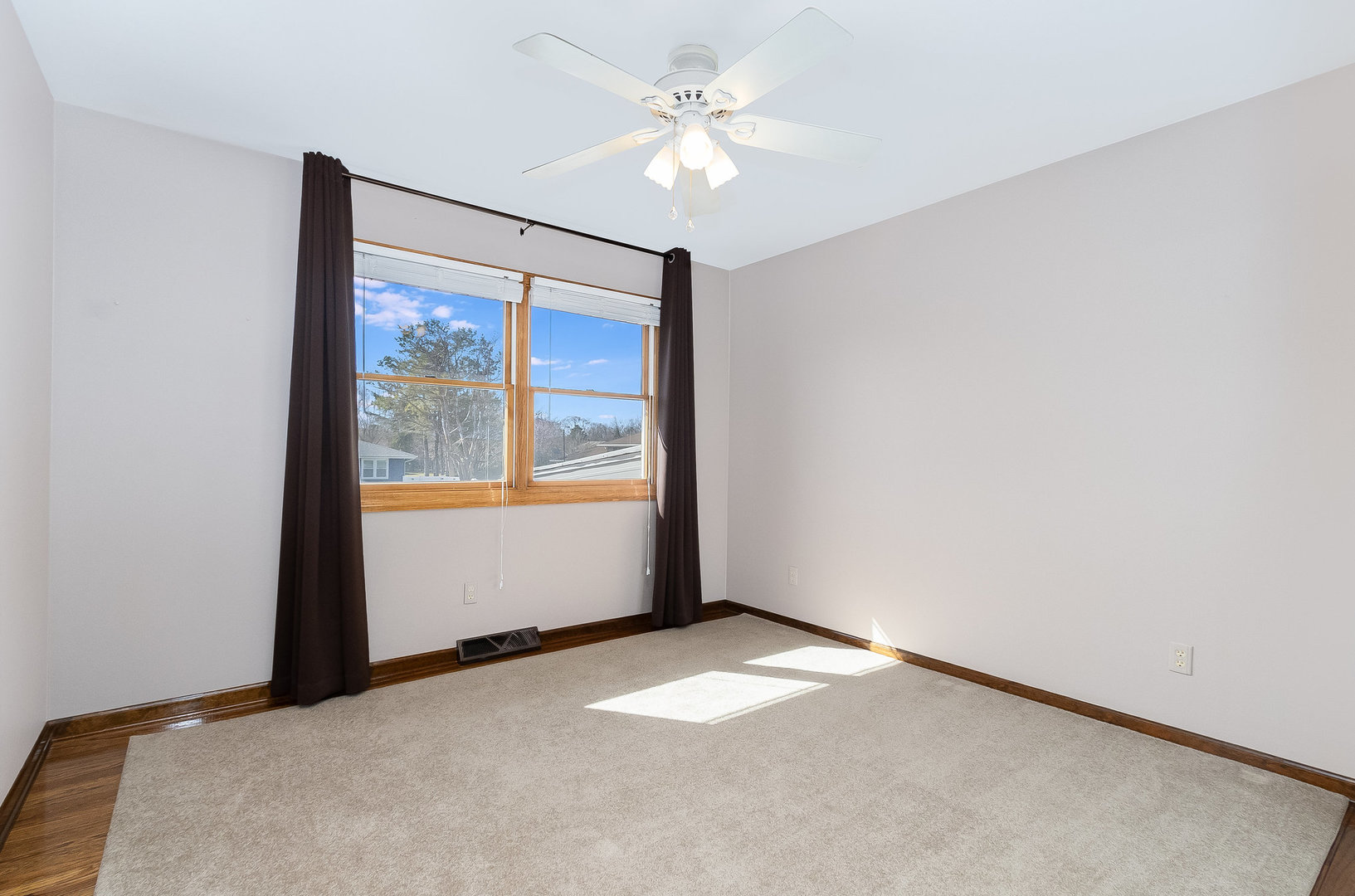 25121 West Willow Drive Plainfield, IL 60544 - Photo 17 of 28 an empty room with a window and a fan