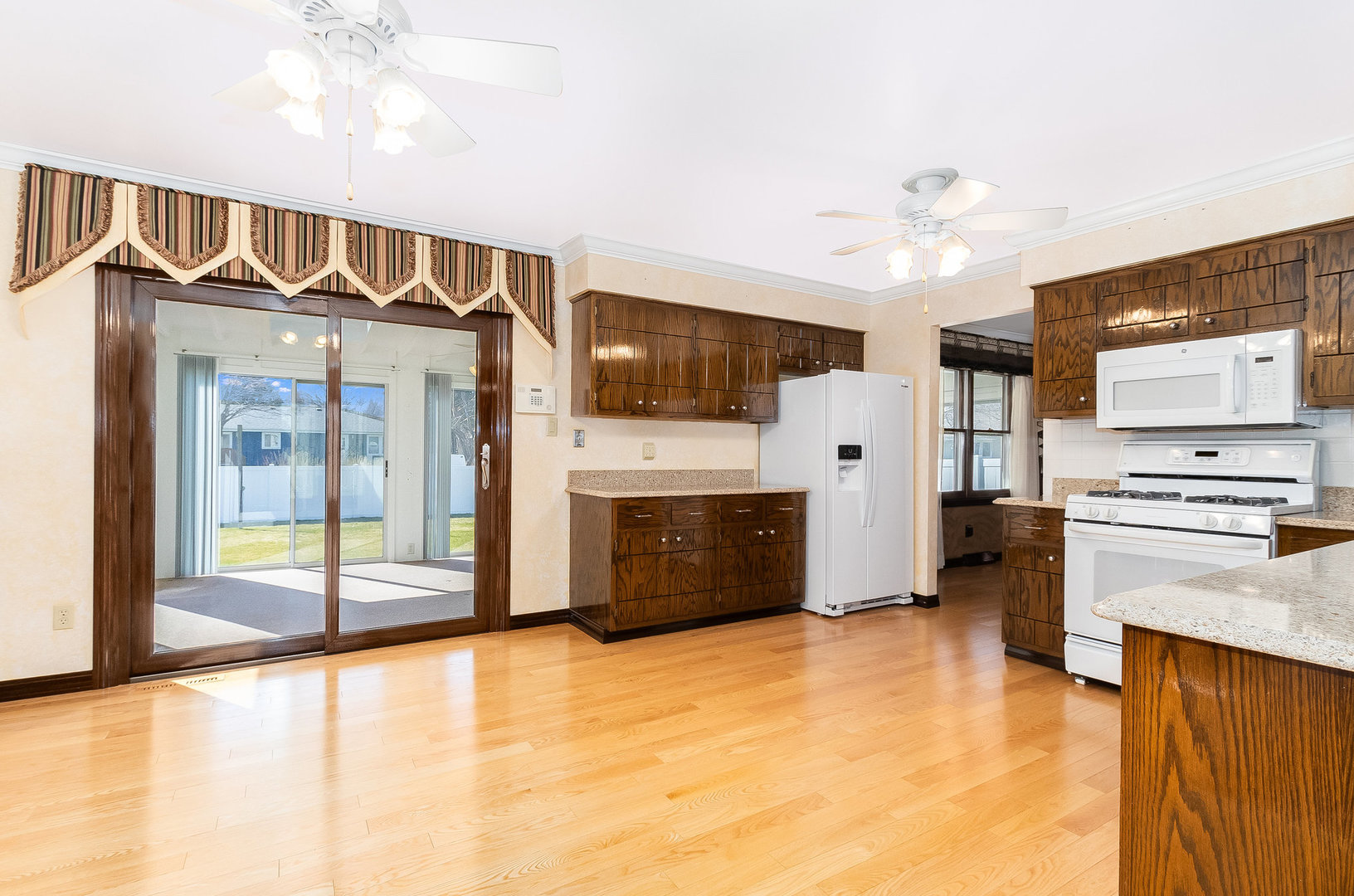 25121 West Willow Drive Plainfield, IL 60544 - Photo 8 of 28 a view of a kitchen with a stove cabinets and entryway