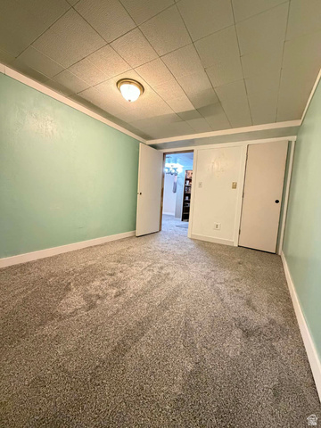 156 D Street Helper, UT 84526 - Photo 22 of 24 Spare room with light carpet and a paneled ceiling
