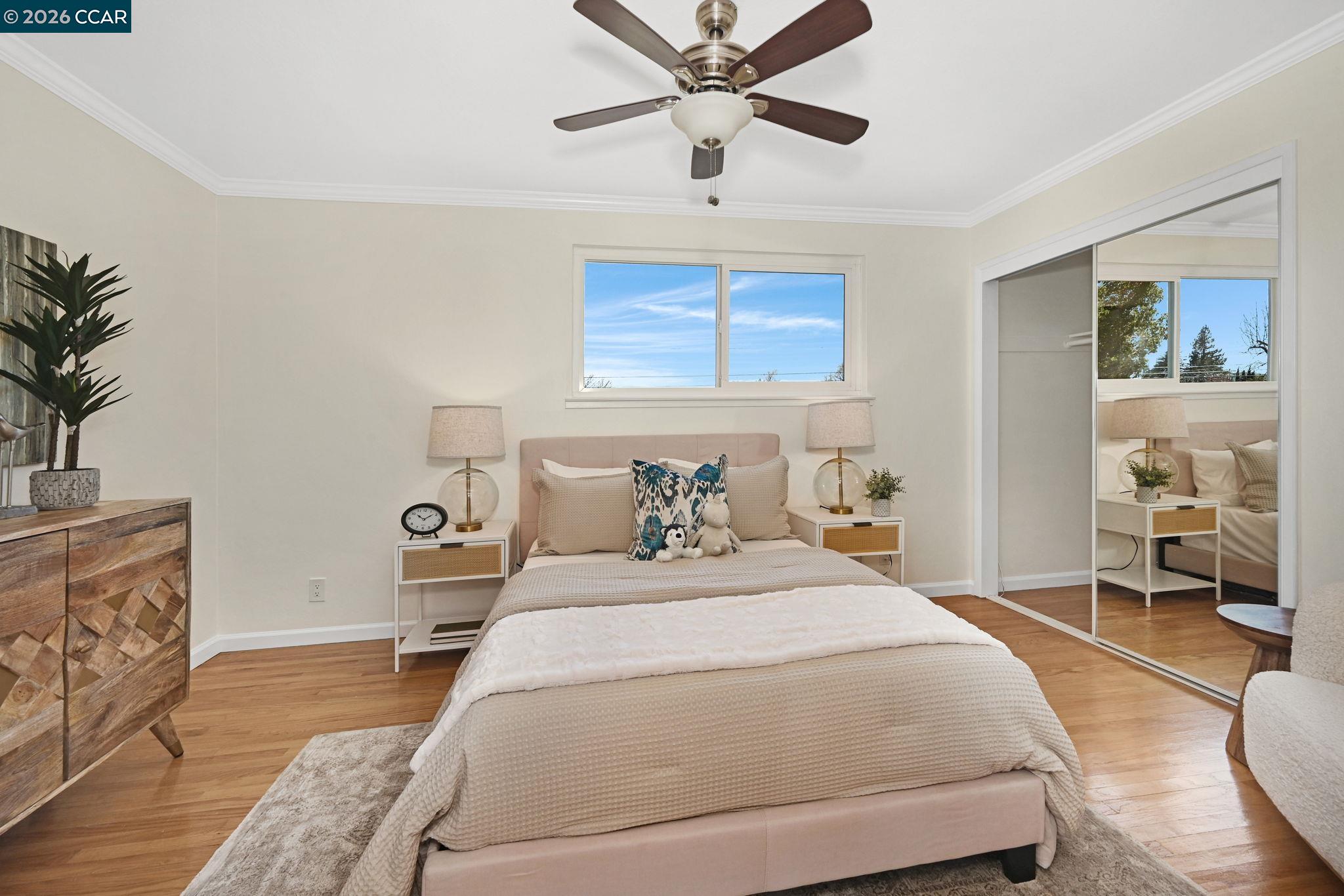 414 Peppertree Road Walnut Creek, CA 94598 - Photo 21 of 49 a bedroom with a large bed and a chandelier fan