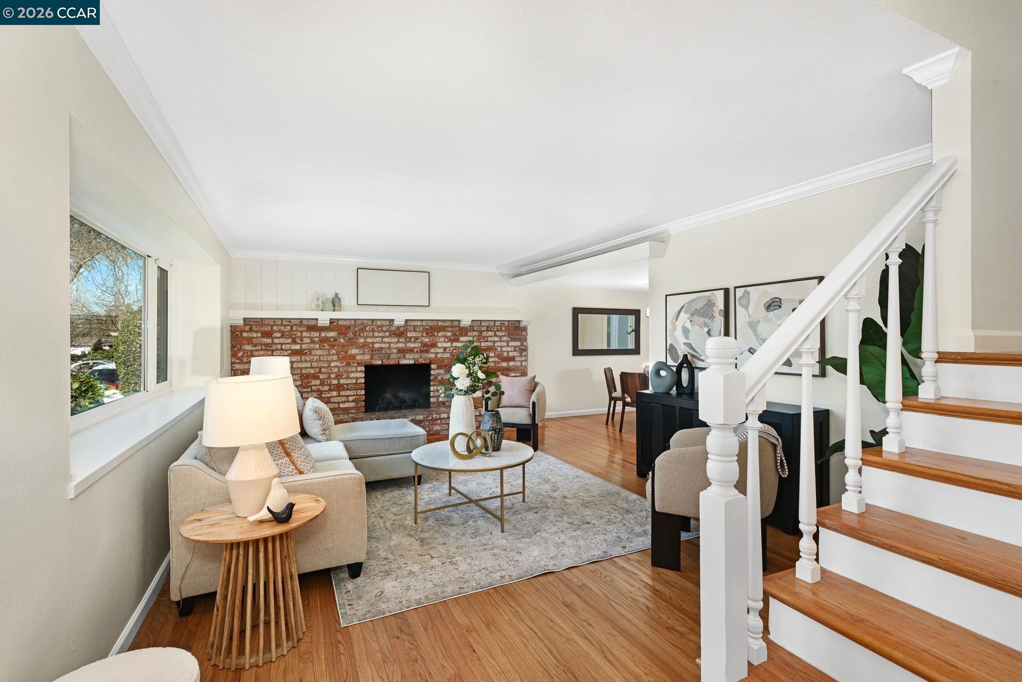 414 Peppertree Road Walnut Creek, CA 94598 - Photo 5 of 49 a living room with fireplace furniture and a wooden floor