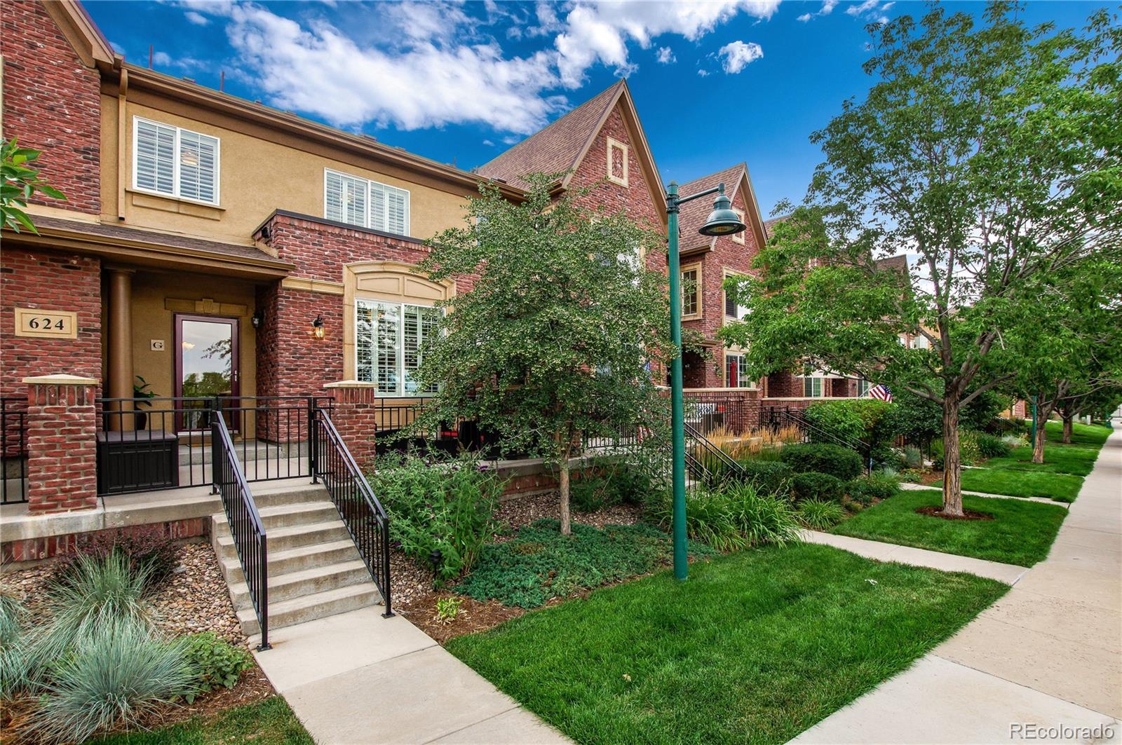624 Green Ash Street, Unit G Highlands Ranch, CO 80129 - Photo 1 of 40 a front view of a house with a yard