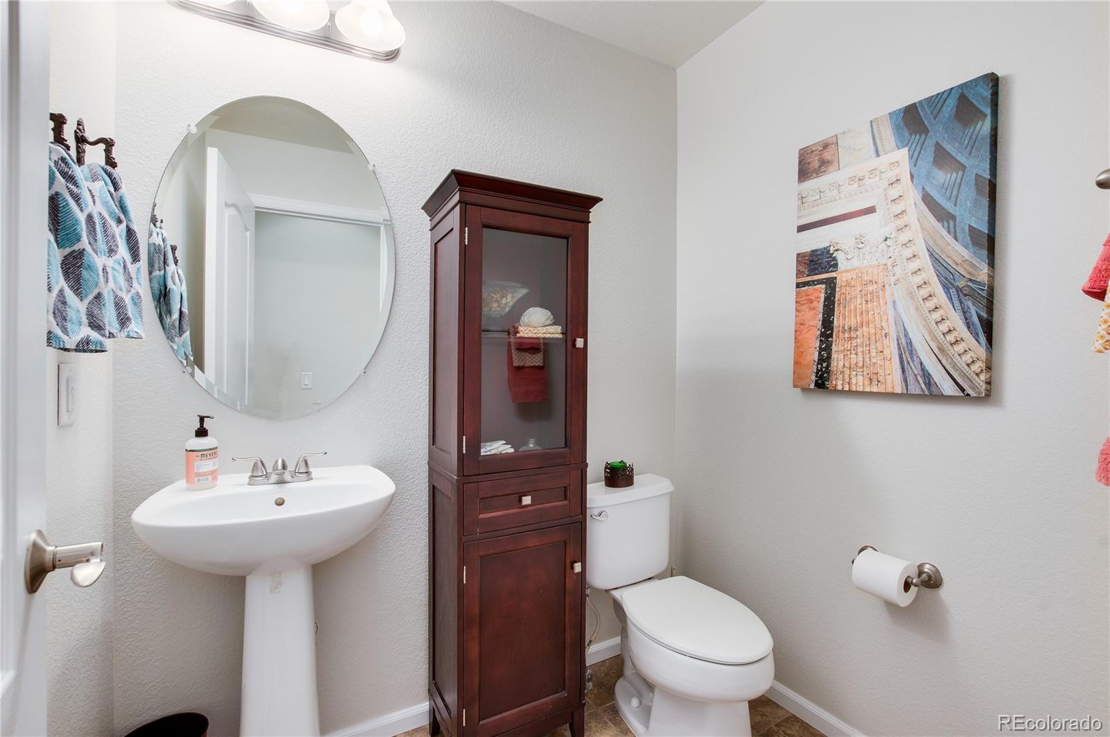 624 Green Ash Street, Unit G Highlands Ranch, CO 80129 - Photo 11 of 40 a bathroom with a toilet sink and mirror