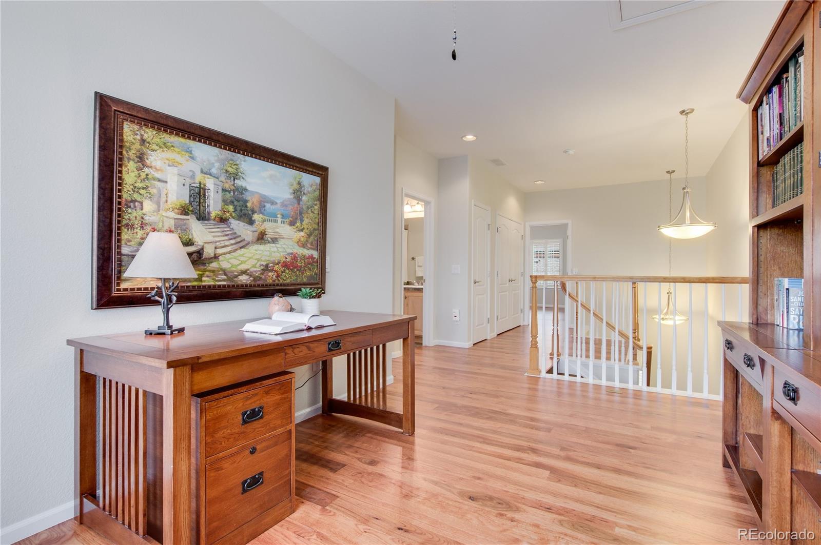 624 Green Ash Street, Unit G Highlands Ranch, CO 80129 - Photo 13 of 40 a room with furniture and wooden floor