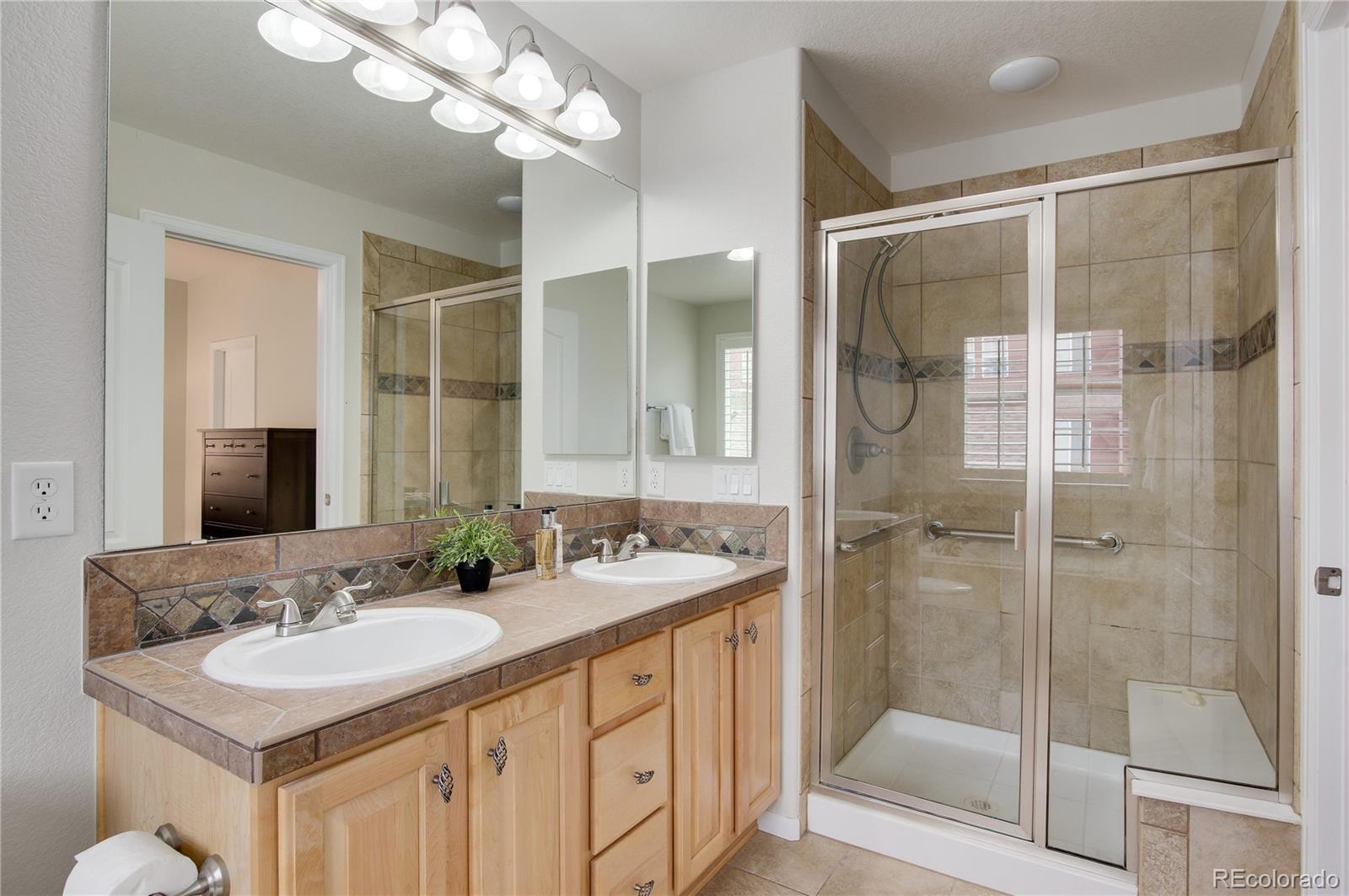 624 Green Ash Street, Unit G Highlands Ranch, CO 80129 - Photo 18 of 40 a bathroom with a sink double vanity and shower
