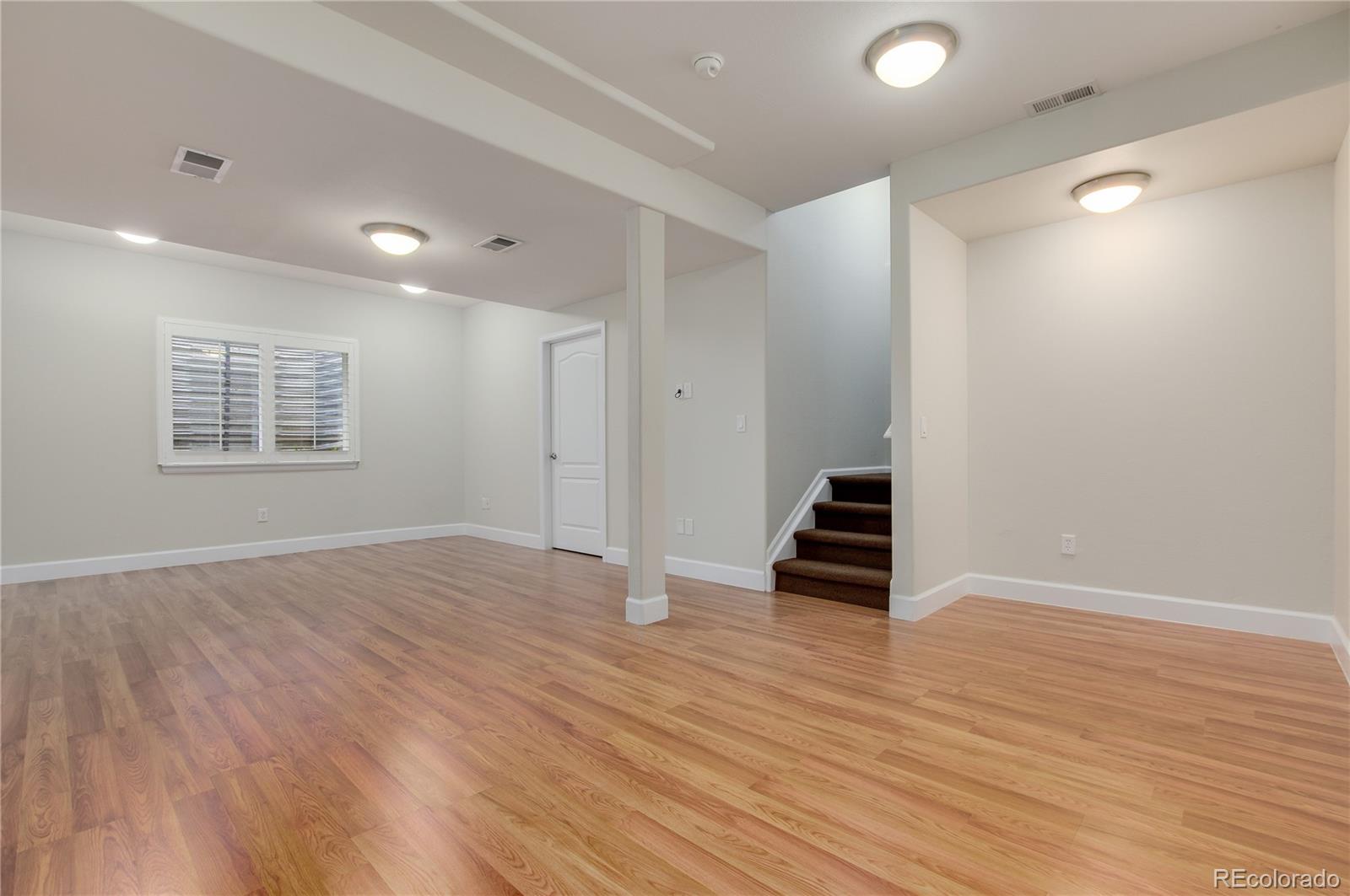 624 Green Ash Street, Unit G Highlands Ranch, CO 80129 - Photo 21 of 40 wooden floor in an empty room with a window