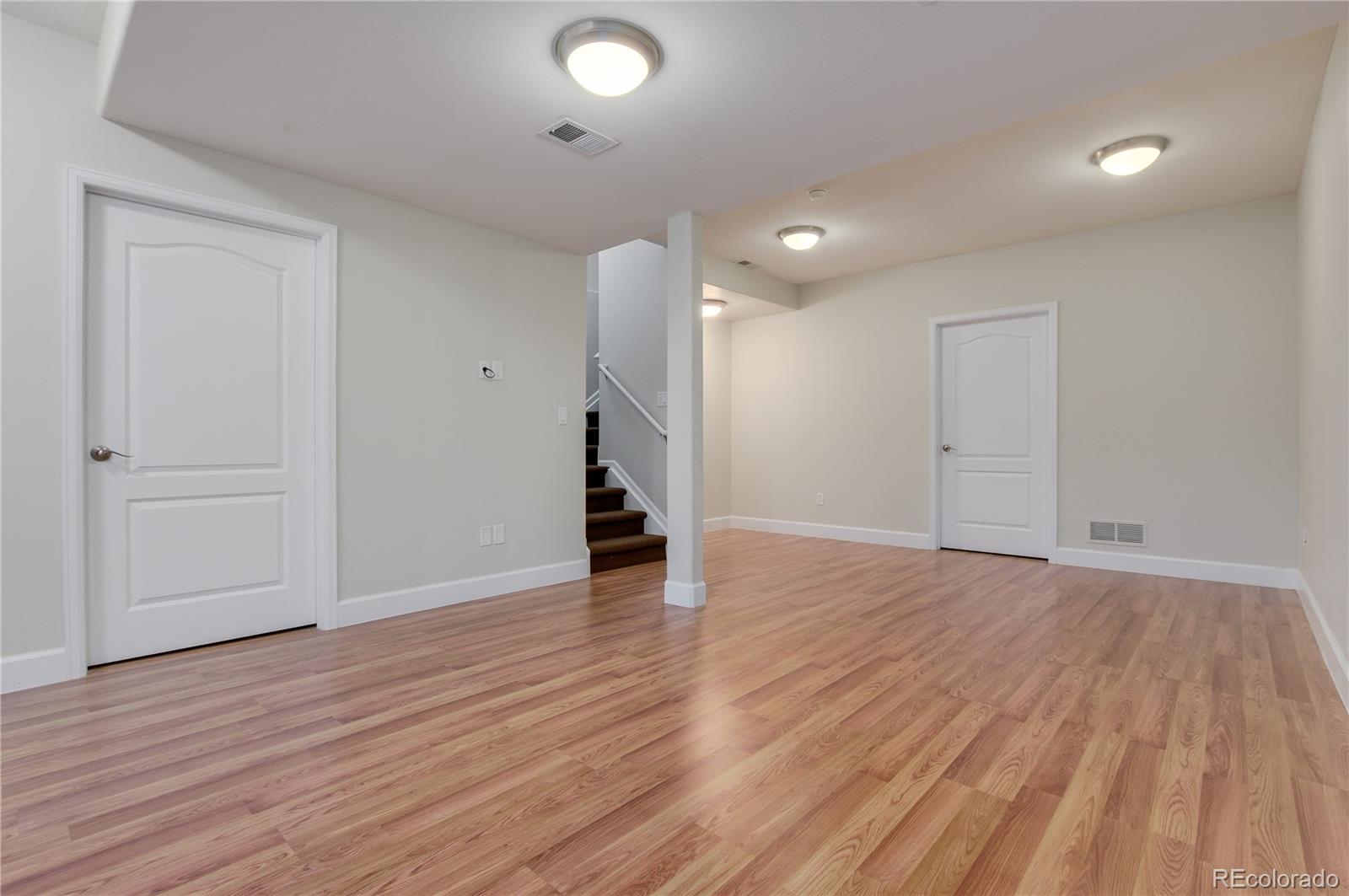 624 Green Ash Street, Unit G Highlands Ranch, CO 80129 - Photo 22 of 40 a view of an empty room with wooden floor