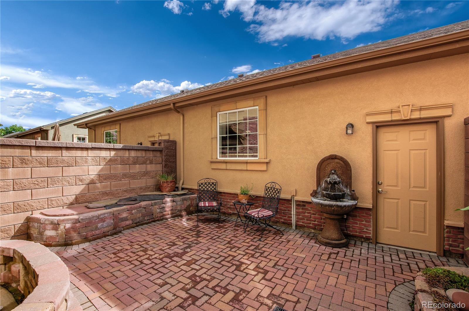 624 Green Ash Street, Unit G Highlands Ranch, CO 80129 - Photo 23 of 40 a backyard of a house with barbeque oven table and chairs