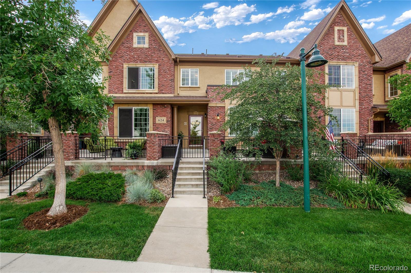 624 Green Ash Street, Unit G Highlands Ranch, CO 80129 - Photo 3 of 40 a front view of a house with a yard