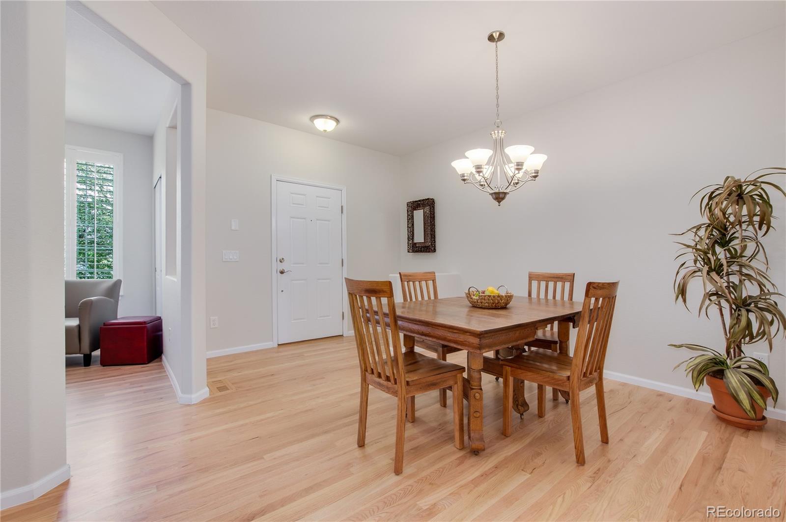 624 Green Ash Street, Unit G Highlands Ranch, CO 80129 - Photo 6 of 40 a view of a dining room with furniture and wooden floor