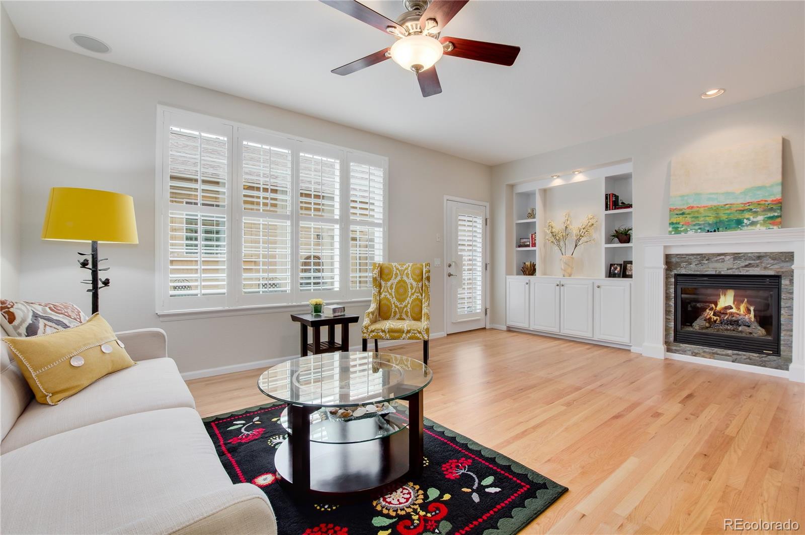 624 Green Ash Street, Unit G Highlands Ranch, CO 80129 - Photo 10 of 40 a living room with furniture and a fireplace