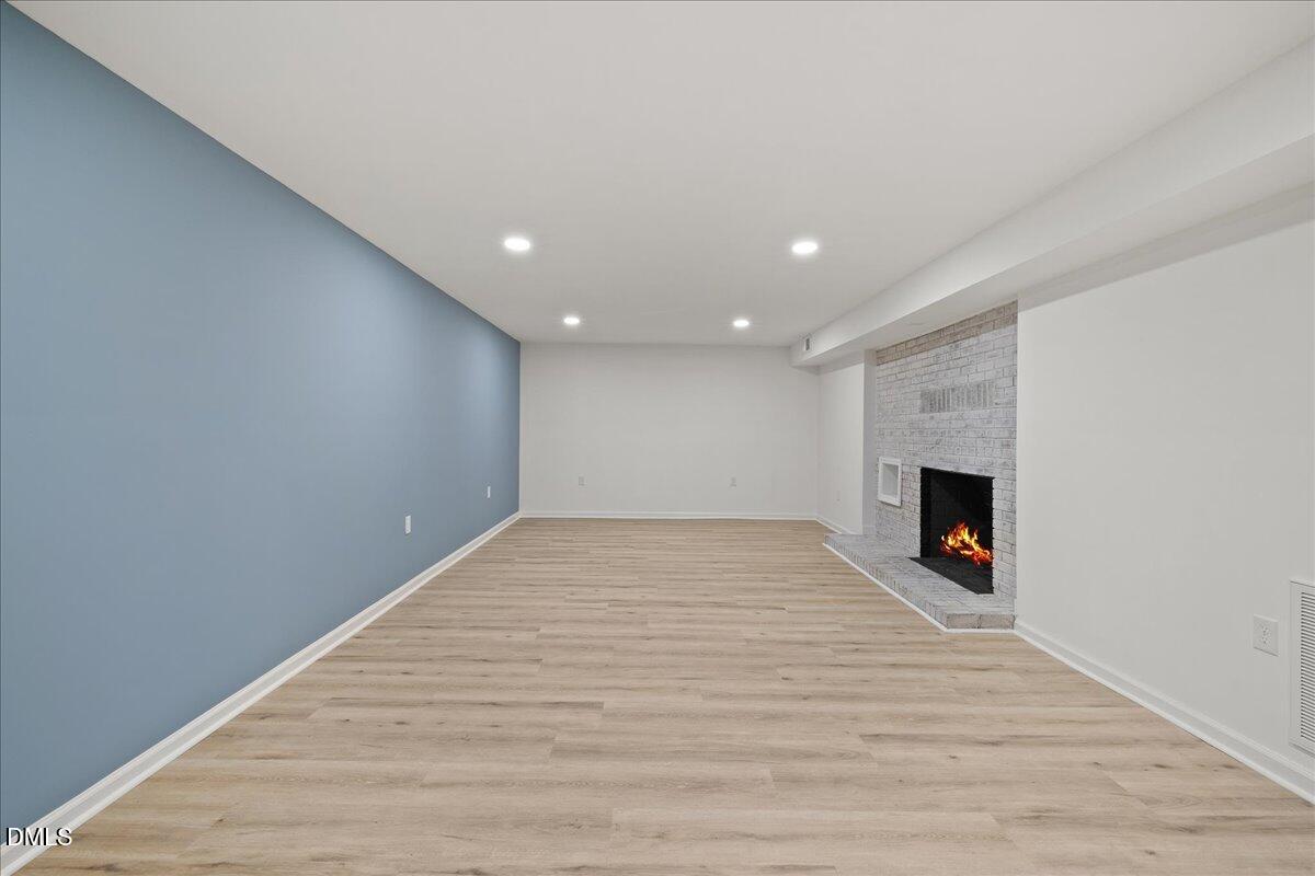 1615 Carbonton Road Sanford, NC 27330 - Photo 43 of 49 a view of empty room with wooden floor and fireplace