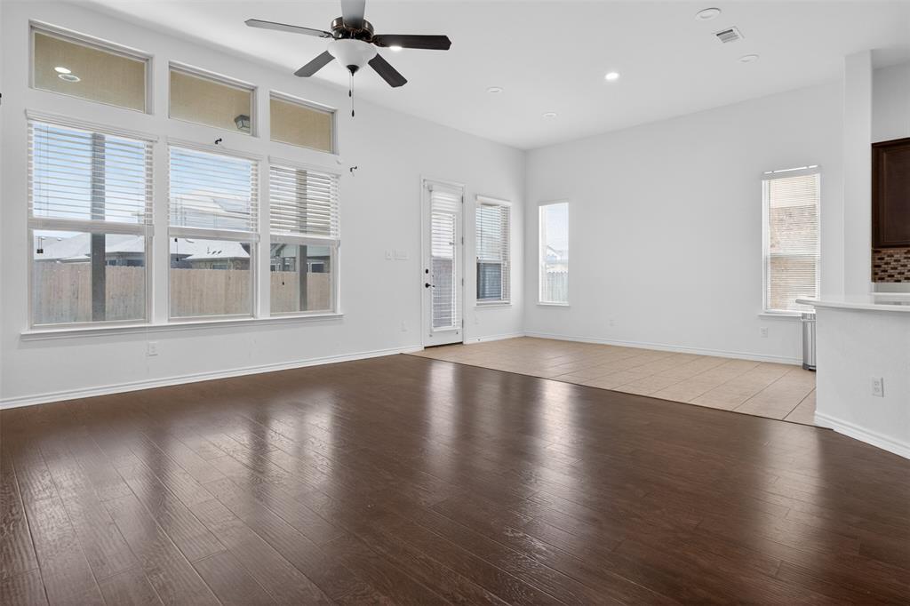 8728 Maple Ridge Trail Fort Worth, TX 76244 - Photo 19 of 40 Spacious living area featuring dark wood-finish flooring, high ceilings, recessed lighting, and a ceiling fan