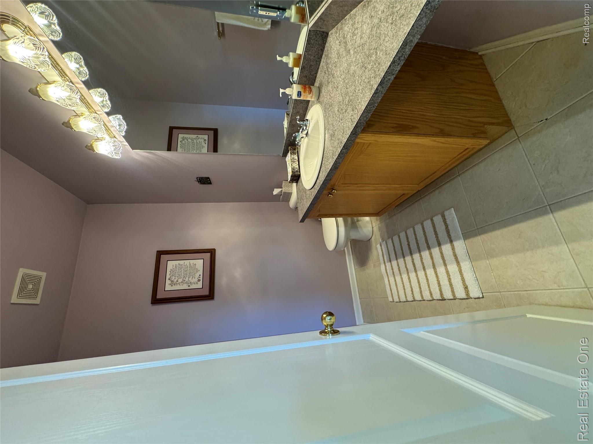 1668 South Shore Drive Rochester, MI 48307 - Photo 22 of 27 Bathroom with vanity and light tile patterned floors