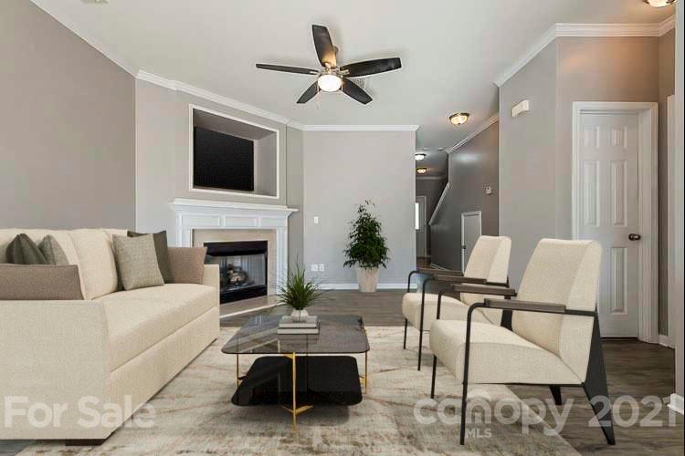 1906 Travertine Lane Fort Mill, SC 29708 - Photo 2 of 17 a living room with furniture a flat screen tv and a fireplace