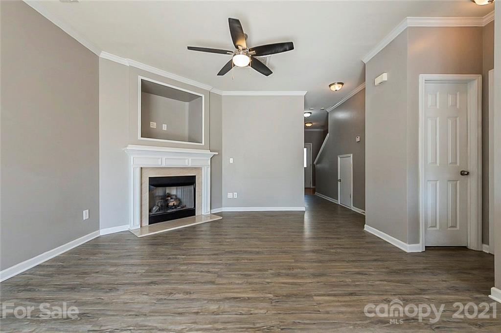 1906 Travertine Lane Fort Mill, SC 29708 - Photo 5 of 17 a view of empty room with wooden floor and a ceiling fan