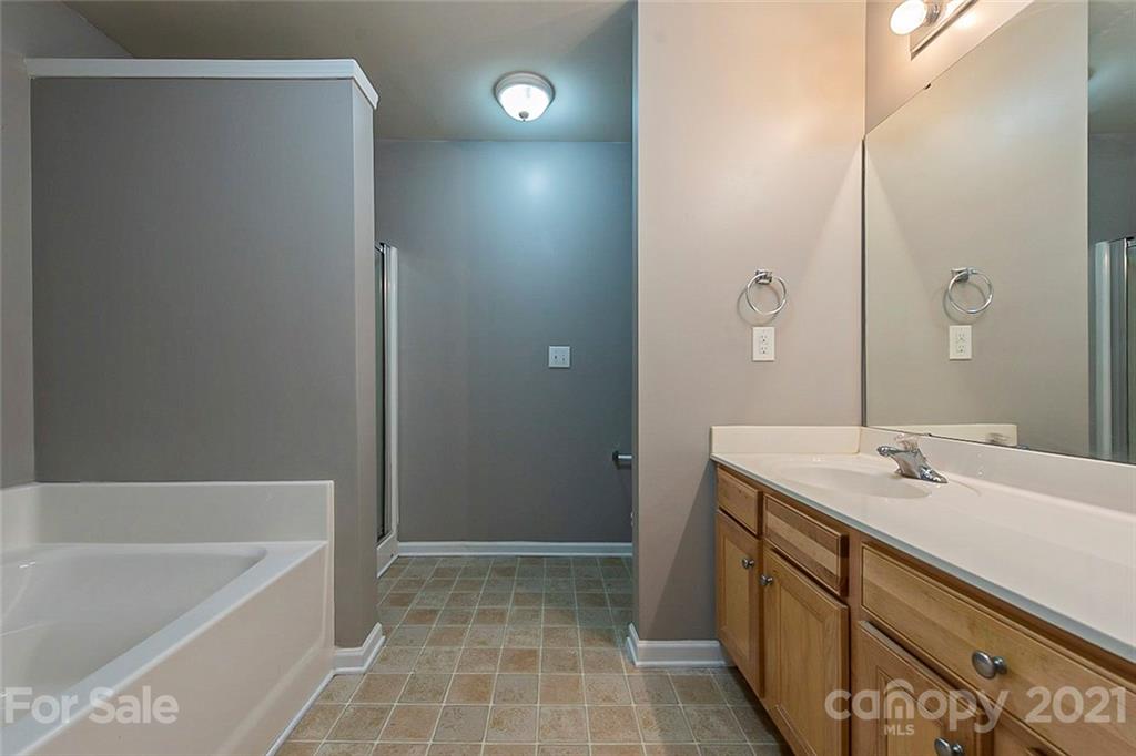 1906 Travertine Lane Fort Mill, SC 29708 - Photo 6 of 17 a bathroom with a tub sink and mirror