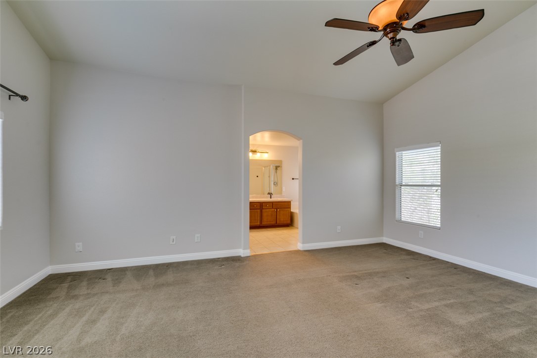8909 Houston Ridge Avenue Las Vegas, NV 89178 - Photo 33 of 45 A spacious bedroom retreat offers vaulted ceilings and an adjoining private bathroom.