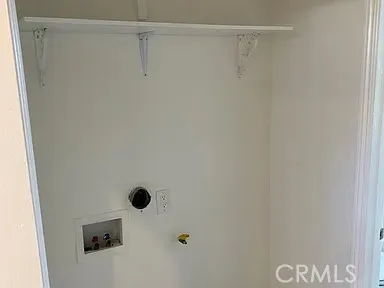 an empty room with wooden floor and closet