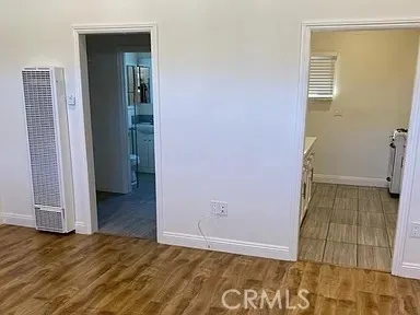 an empty room with wooden floor and closet