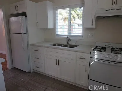 a kitchen with appliances cabinets and a sink