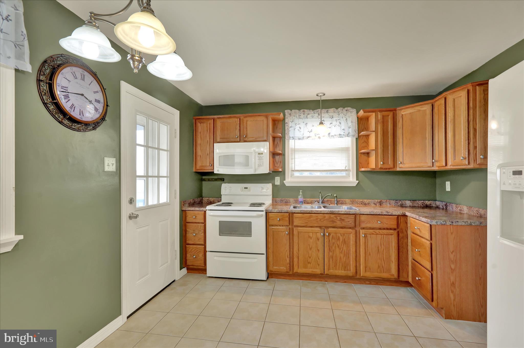 3027 Limekiln Road Birdsboro, PA 19508 - Photo 13 of 37 a kitchen with a stove window and cabinets