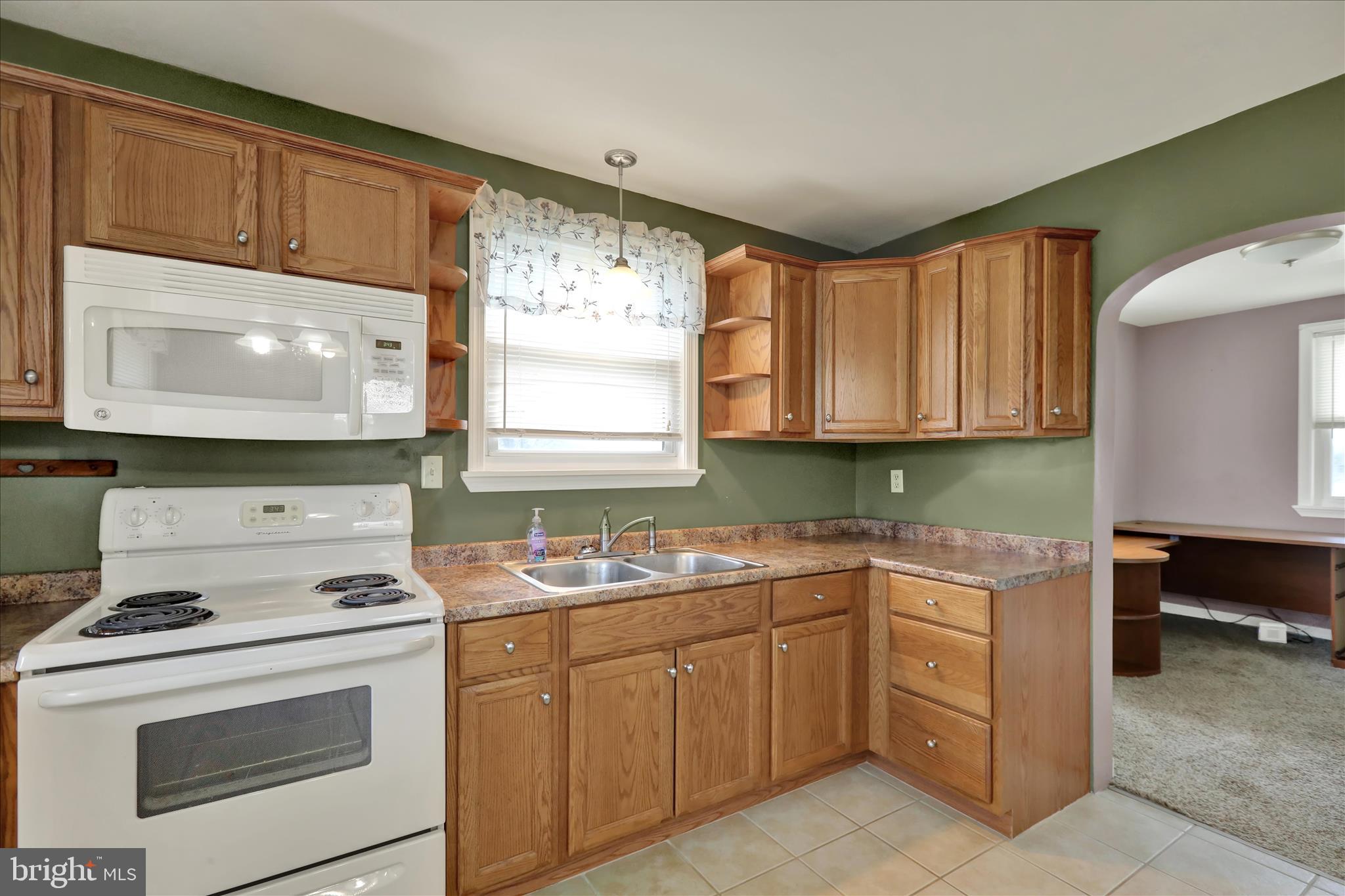 3027 Limekiln Road Birdsboro, PA 19508 - Photo 14 of 37 a kitchen with cabinets appliances a sink and a window