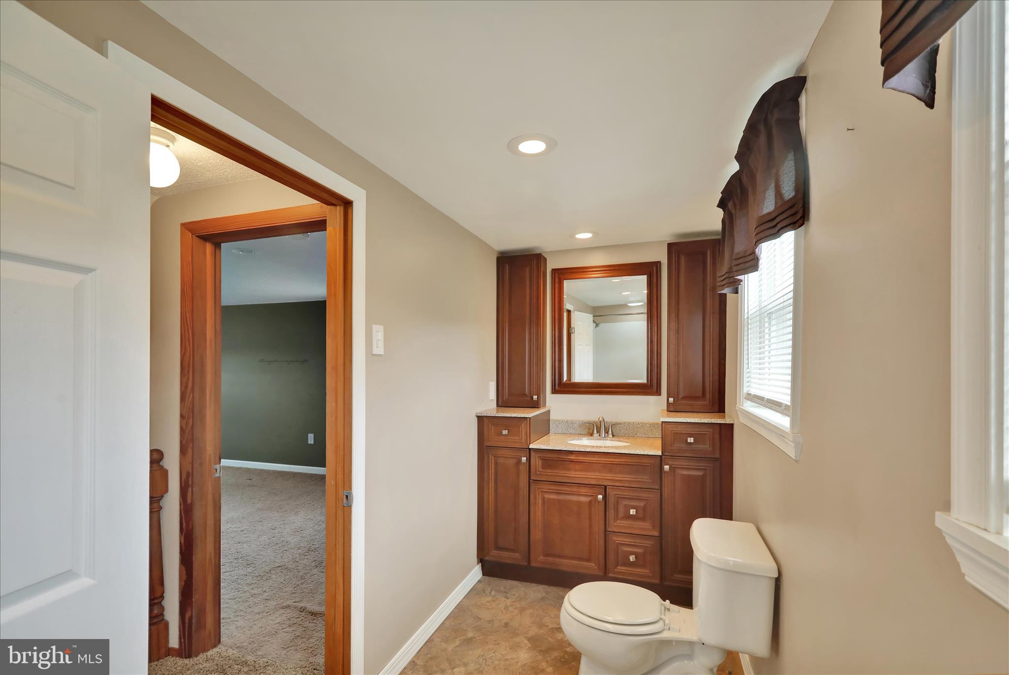 3027 Limekiln Road Birdsboro, PA 19508 - Photo 21 of 37 a bathroom with a toilet sink vanity and mirror