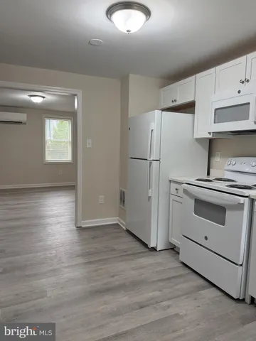 a kitchen with granite countertop a refrigerator and a stove