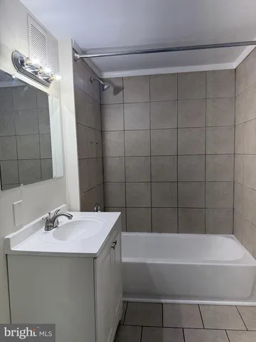 a bathroom with a bathtub a sink and a mirror