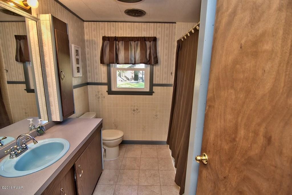 3321 Aberdeen Road Moscow, PA 18444 - Photo 14 of 20 a bathroom with a granite countertop sink toilet and shower