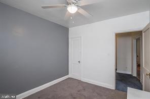 1618 Roundhill Road Baltimore, MD 21218 - Photo 32 of 50 an empty room with a ceiling fan and a window