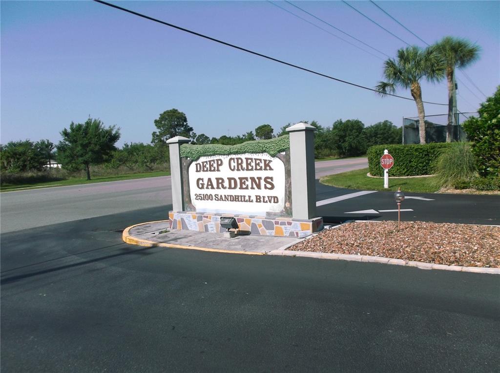 25100 Sandhill Boulevard, Unit 202 Punta Gorda, FL 33983 - Photo 2 of 12 a sign on the side of the road