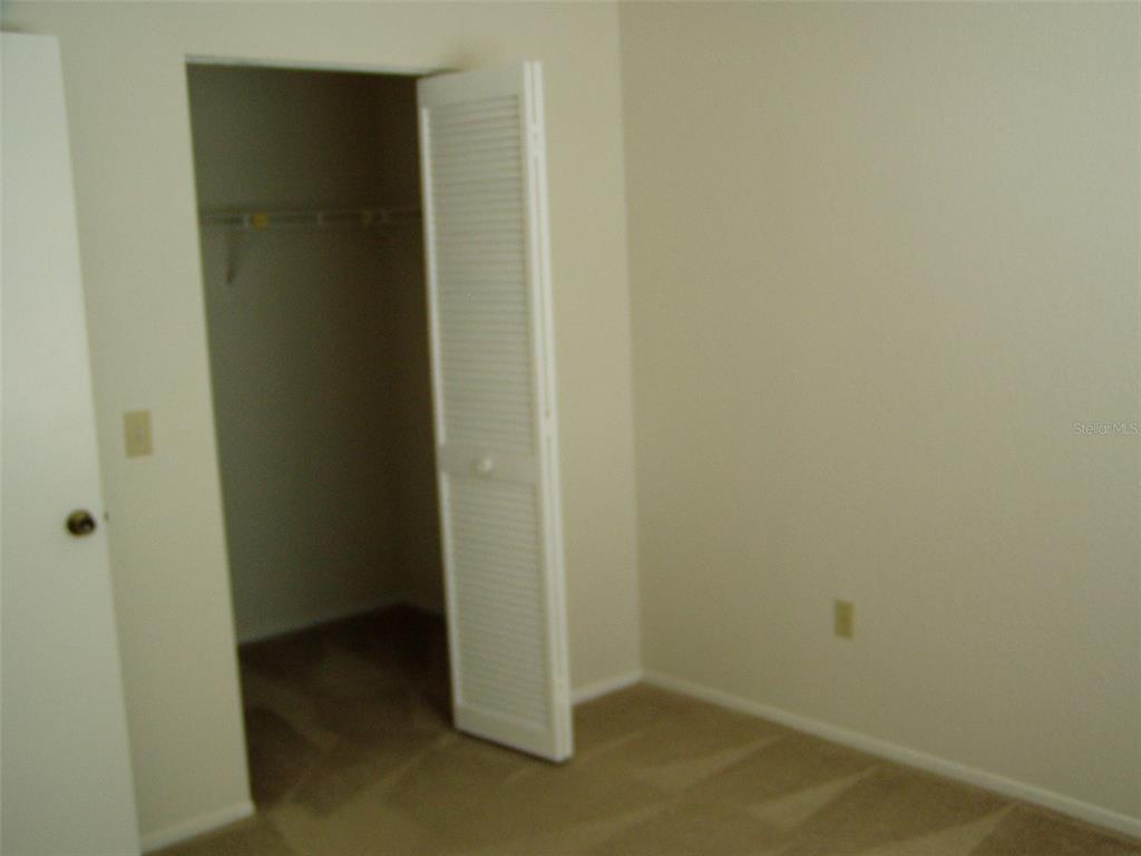25100 Sandhill Boulevard, Unit 202 Punta Gorda, FL 33983 - Photo 4 of 12 an empty room with closet