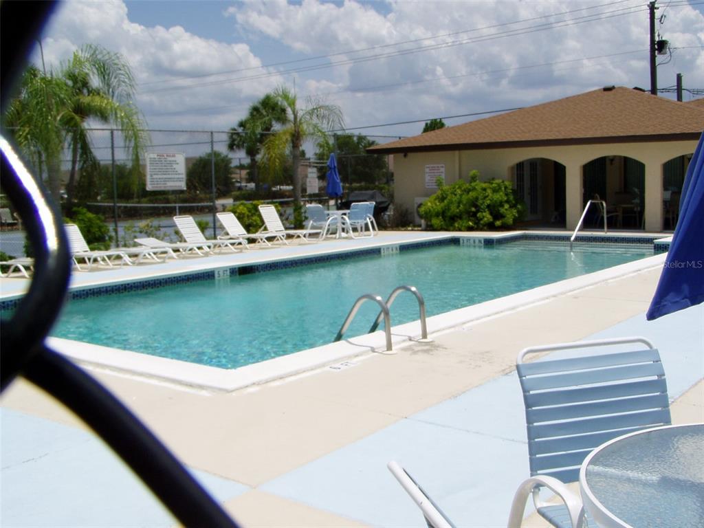 25100 Sandhill Boulevard, Unit 202 Punta Gorda, FL 33983 - Photo 7 of 12 a view of a swimming pool with a patio