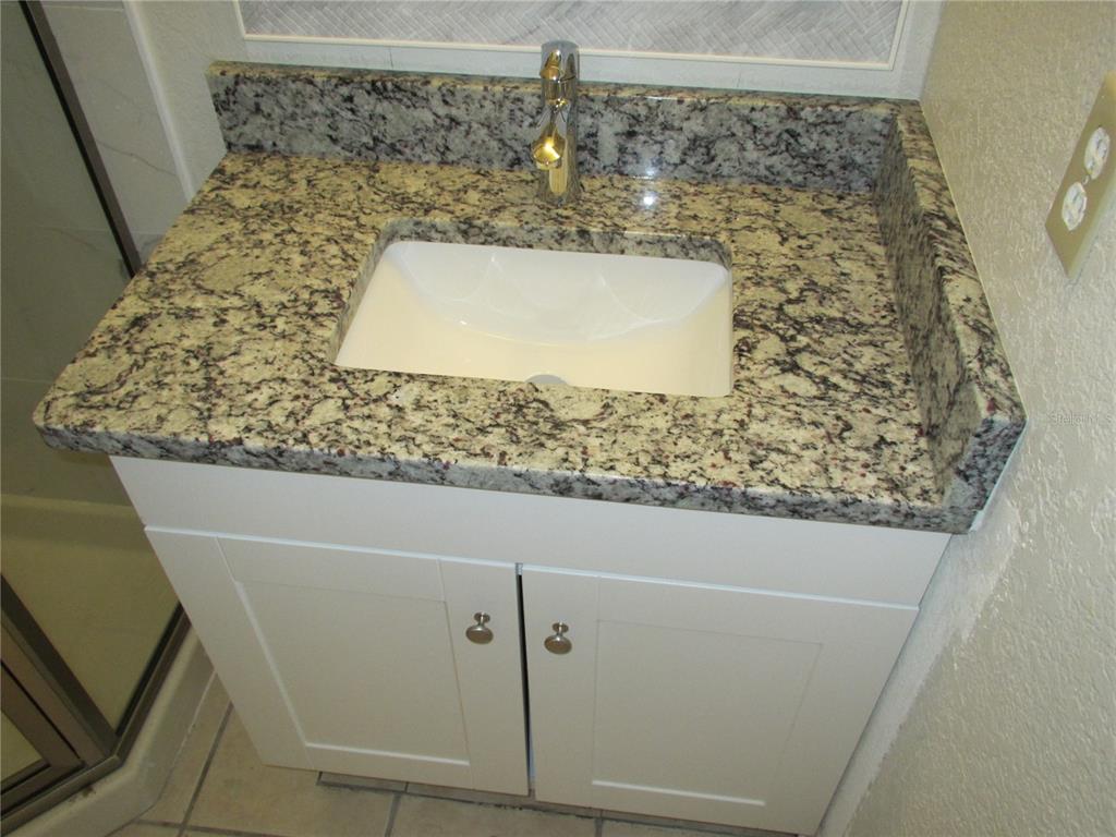 25100 Sandhill Boulevard, Unit 202 Punta Gorda, FL 33983 - Photo 8 of 12 a bathroom with a bathtub