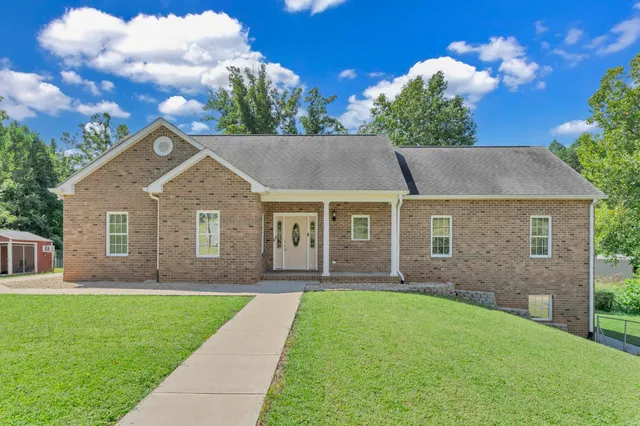 a front view of house with yard and green space
