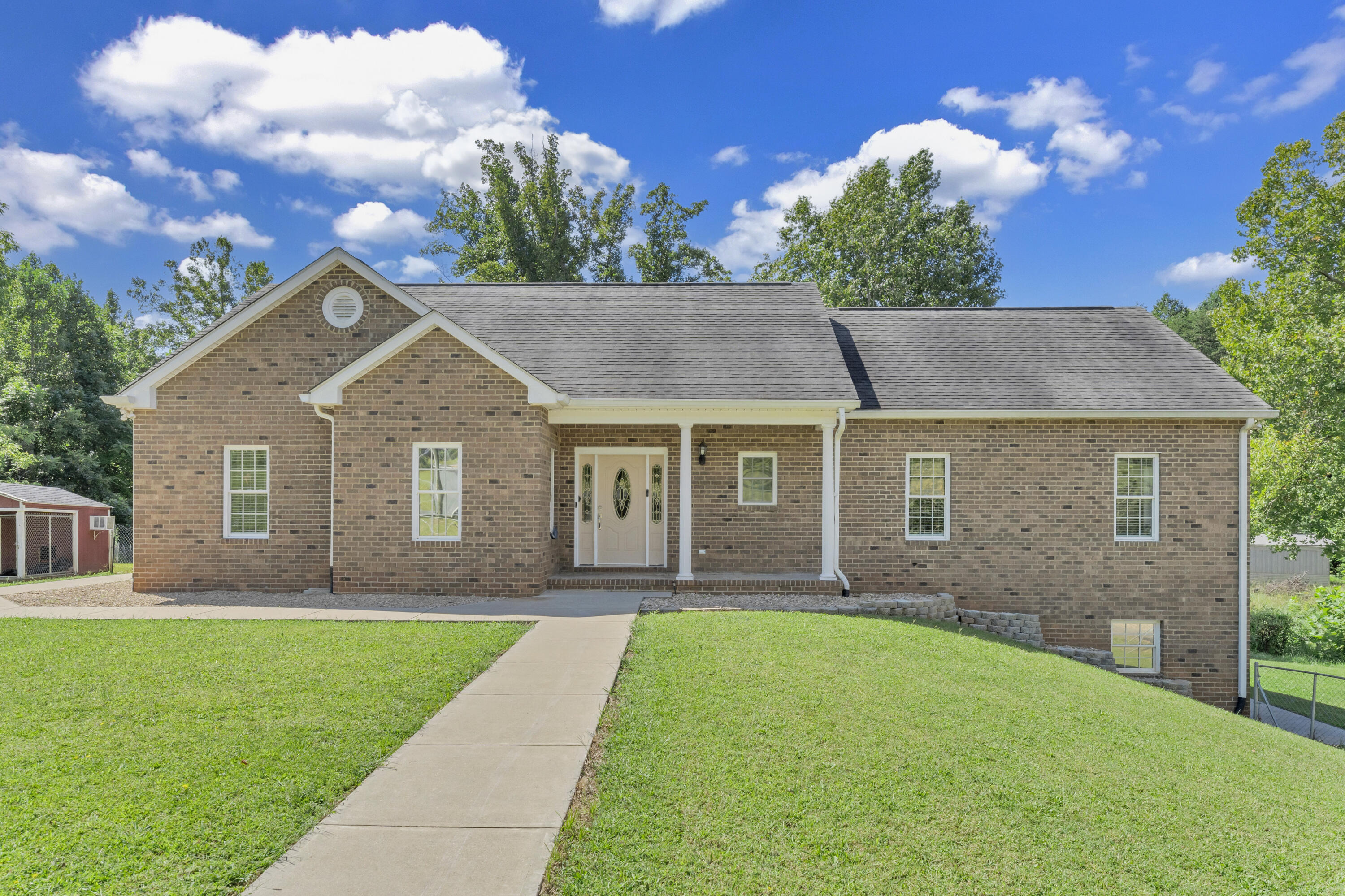 a front view of house with yard and green space