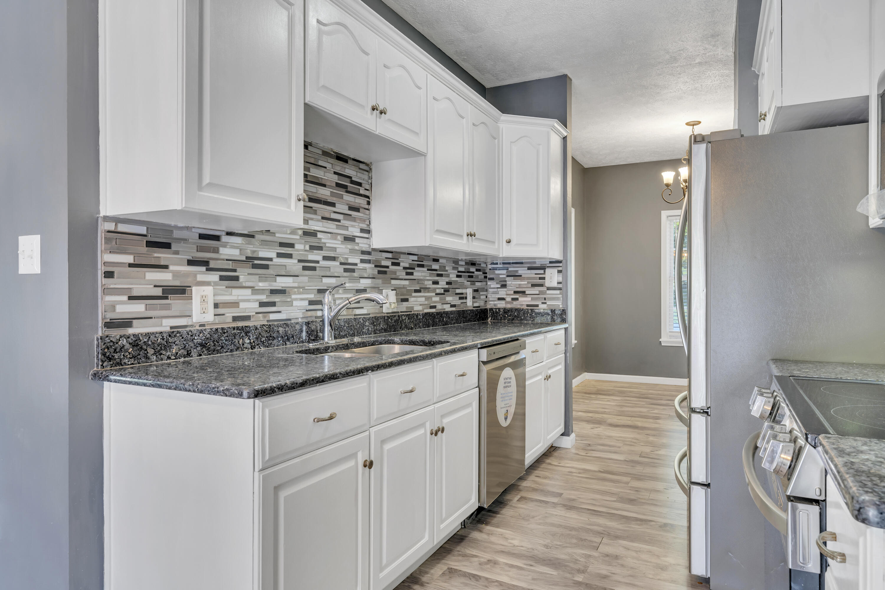 319 Cooks Knob Road Ferrum, VA 24088 - Photo 14 of 80 a bathroom with granite countertop a sink and a wooden cabinets
