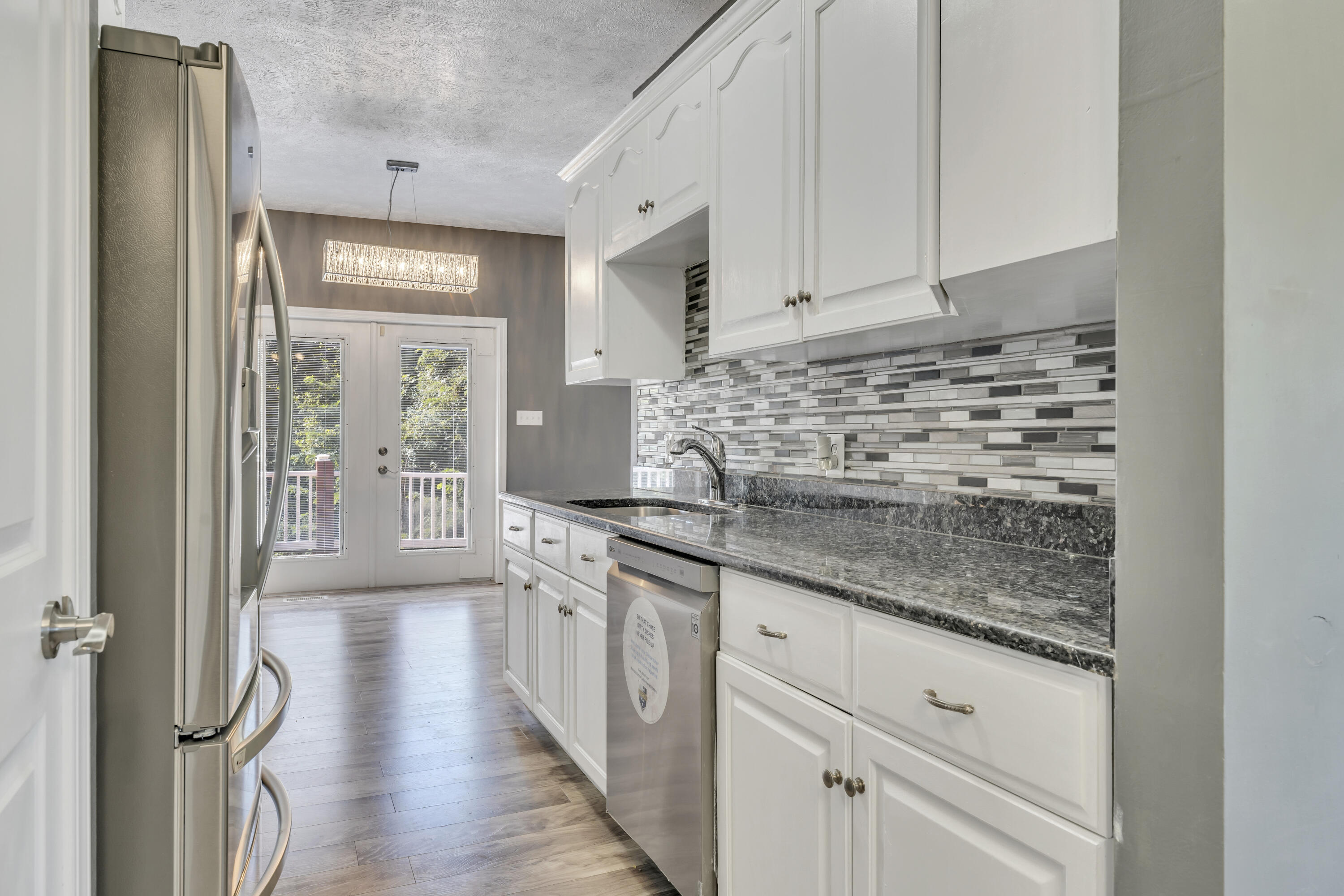 319 Cooks Knob Road Ferrum, VA 24088 - Photo 15 of 80 a kitchen with granite countertop white cabinets and white appliances