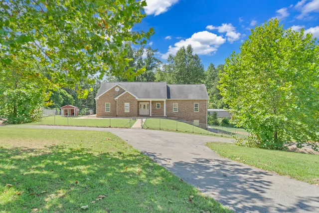a view of a big yard with large trees