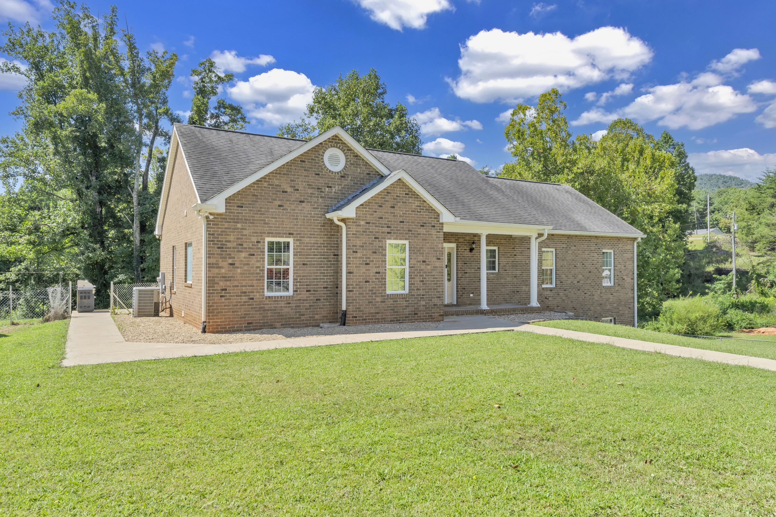 319 Cooks Knob Road Ferrum, VA 24088 - Photo 26 of 80 a front view of a house with a garden and trees