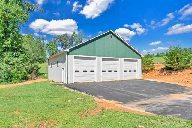 a living room with stainless steel appliances granite countertop furniture and a wooden floor