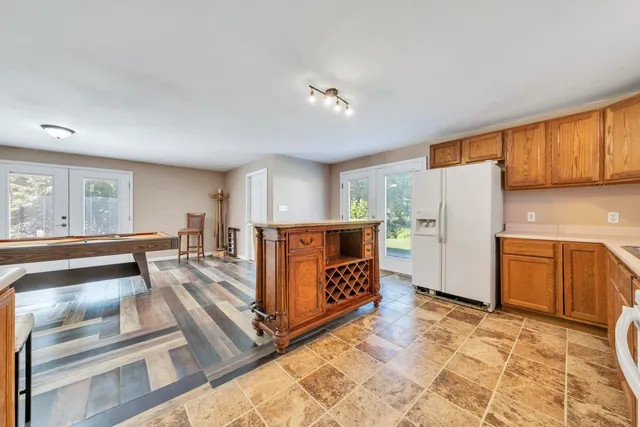 a view of a room with a ceiling fan and a window