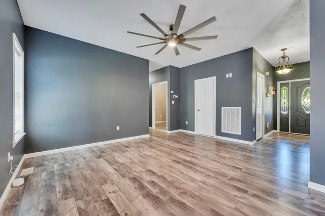 a bathroom with granite countertop a sink and a wooden cabinets