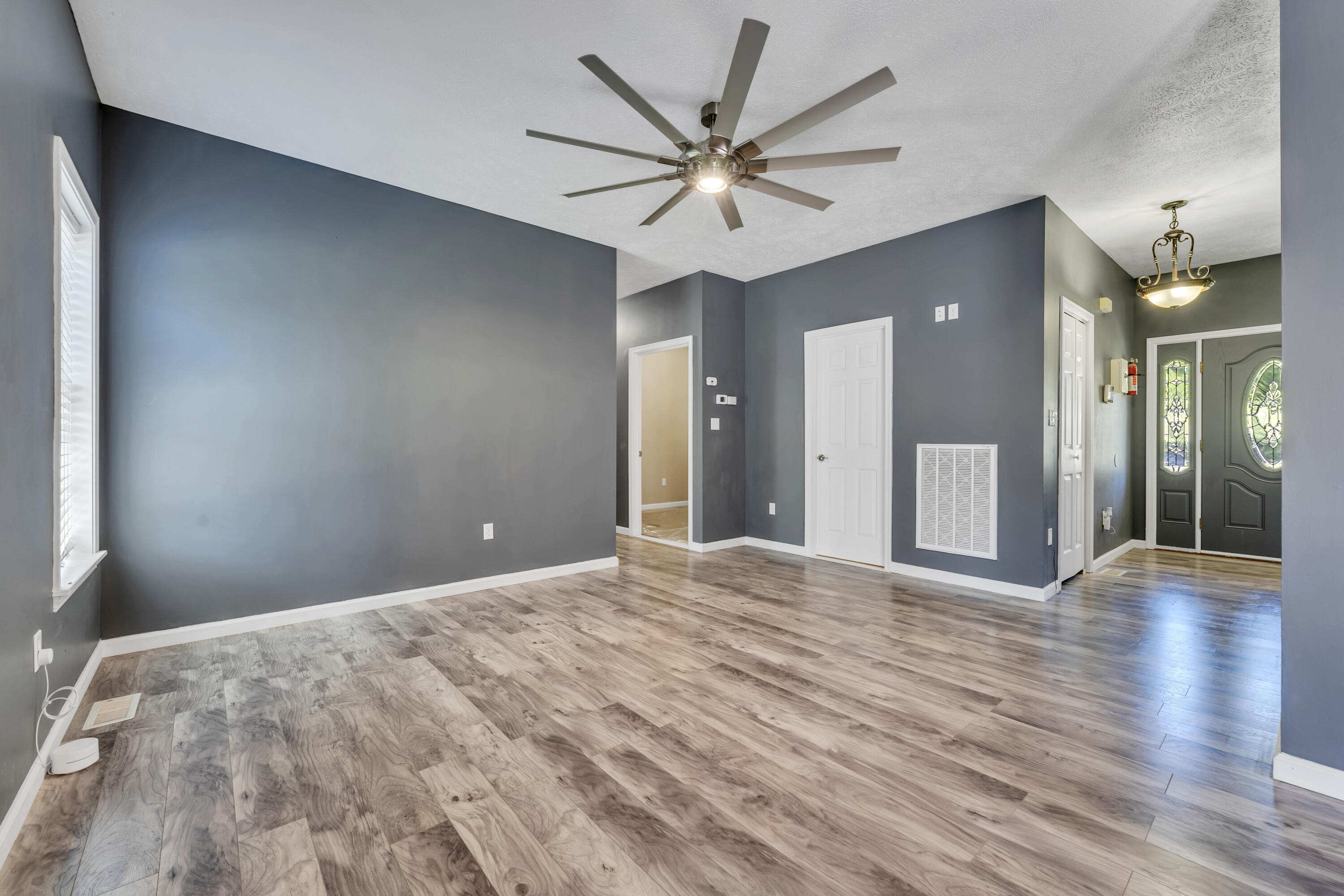 319 Cooks Knob Road Ferrum, VA 24088 - Photo 8 of 80 a view of a livingroom with a chandelier fan and a wooden floor